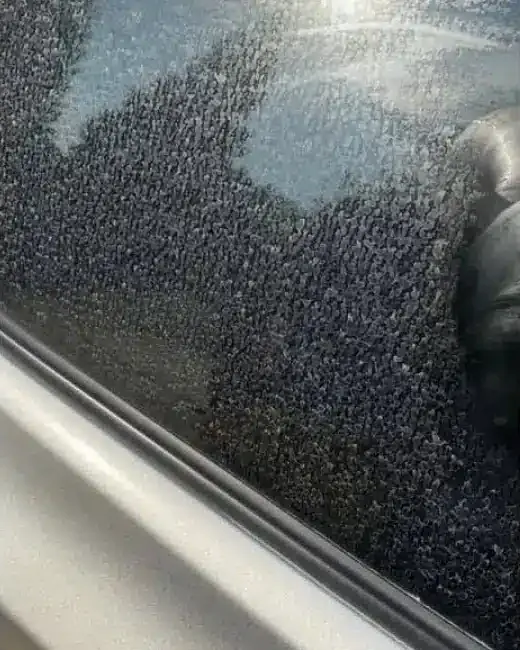 Before: Car window with hard water spots, cleaned with Spotless X2